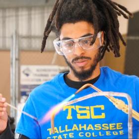 TSC HVAC student welding a pipe in class.