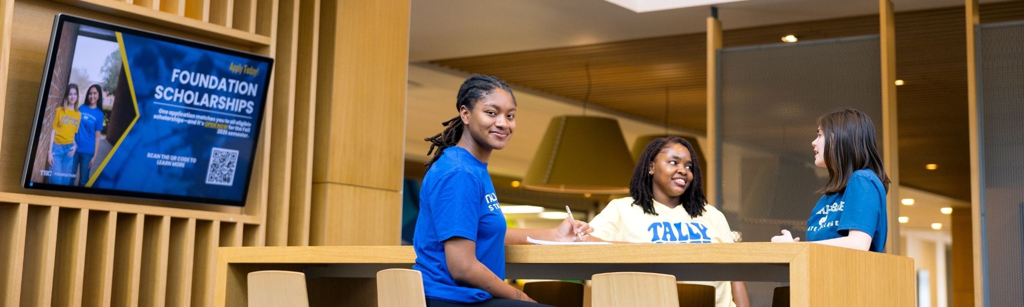 Students sitting at a high-top table in the student union.