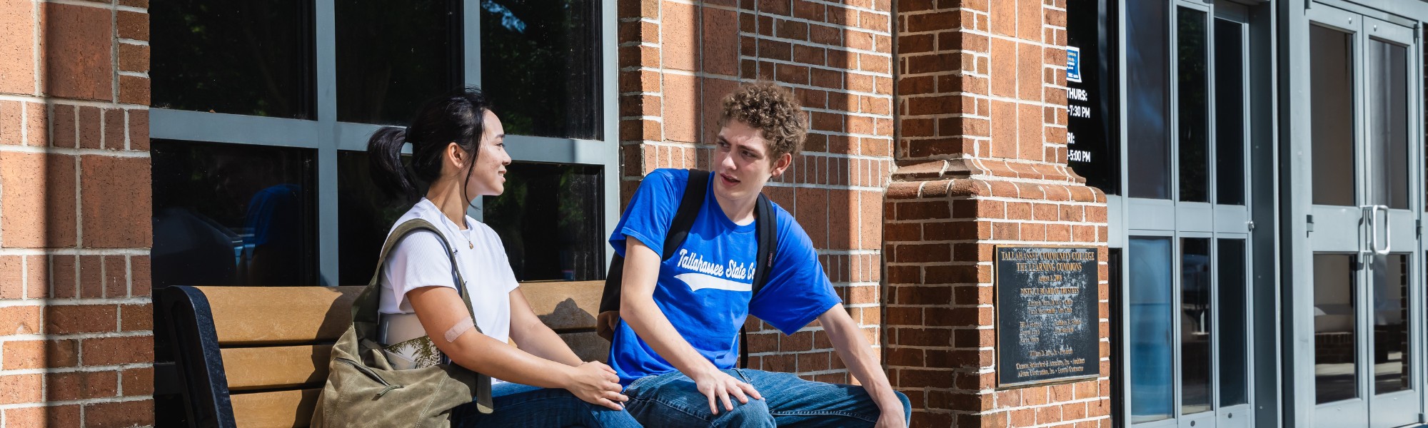 Students sitting and chatting outside the Learning Commons.