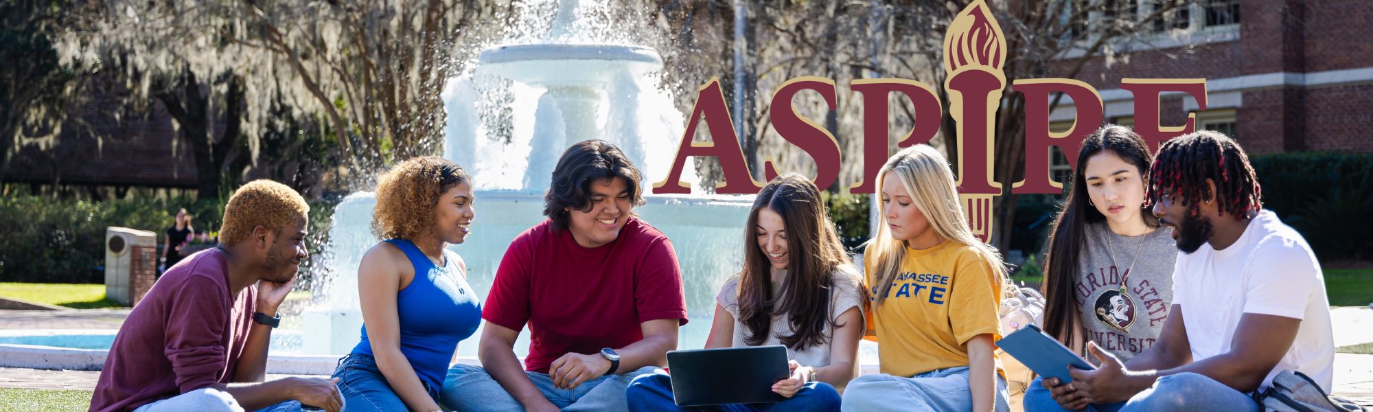 TSC students sitting in front of a fountain on FSU campus.
